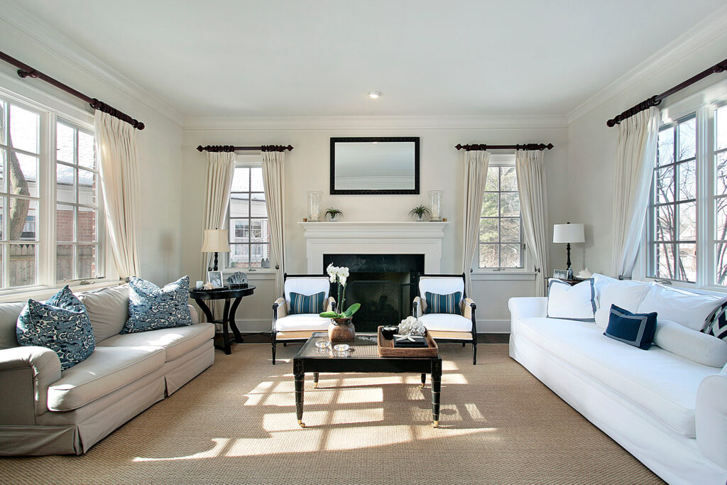Bright living room with white sofas, fireplace, and beige carpet | Yetzer Home Store
